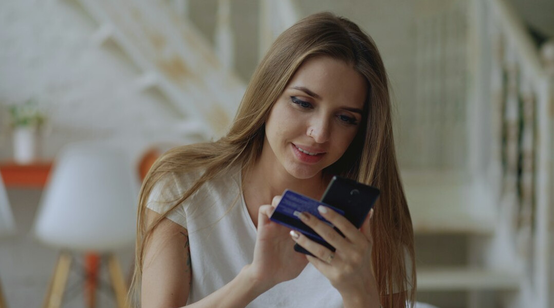 woman checking phone at home