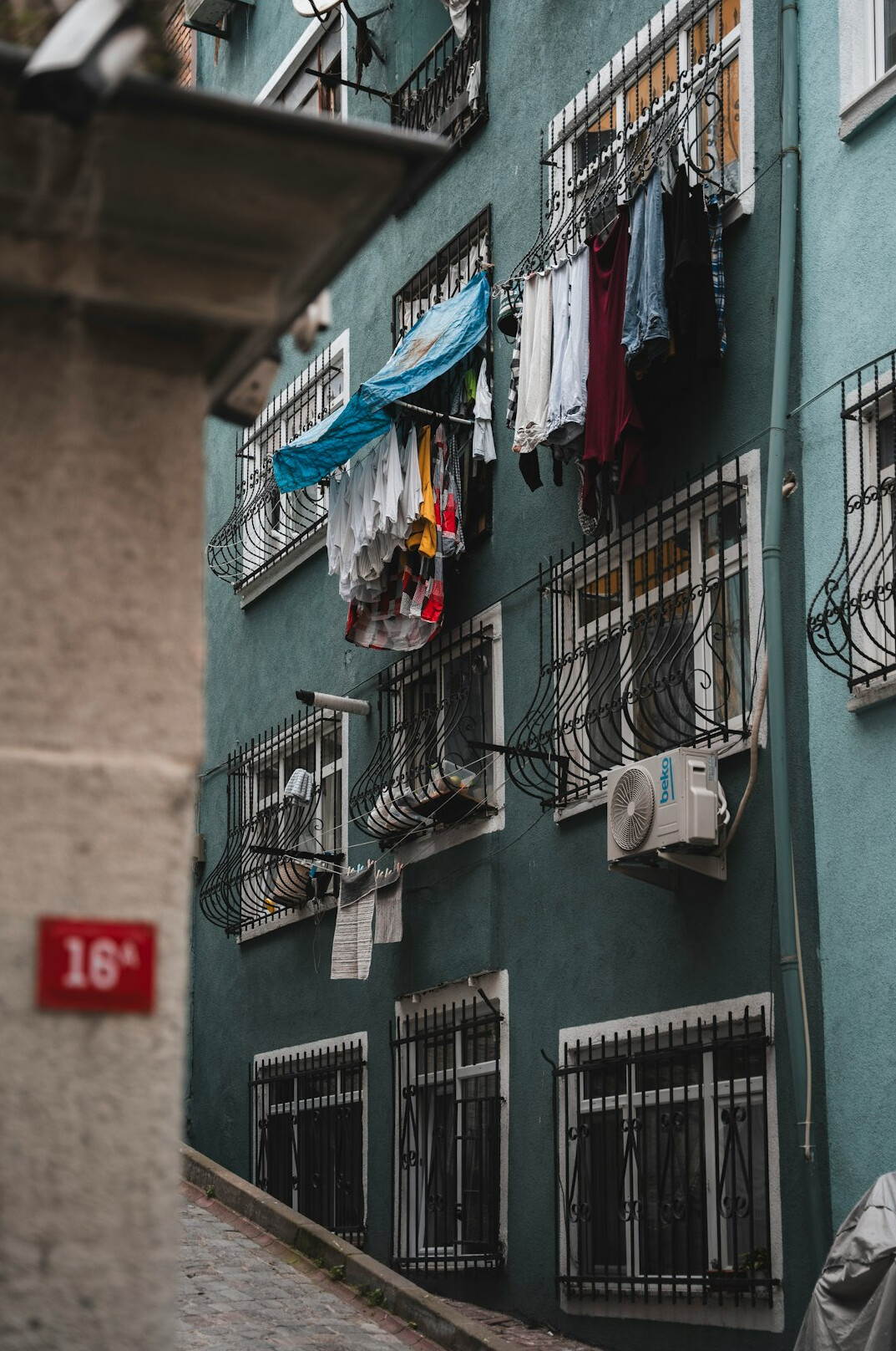 Narrow residential street with hanging laundry in a Chilean neighborhood