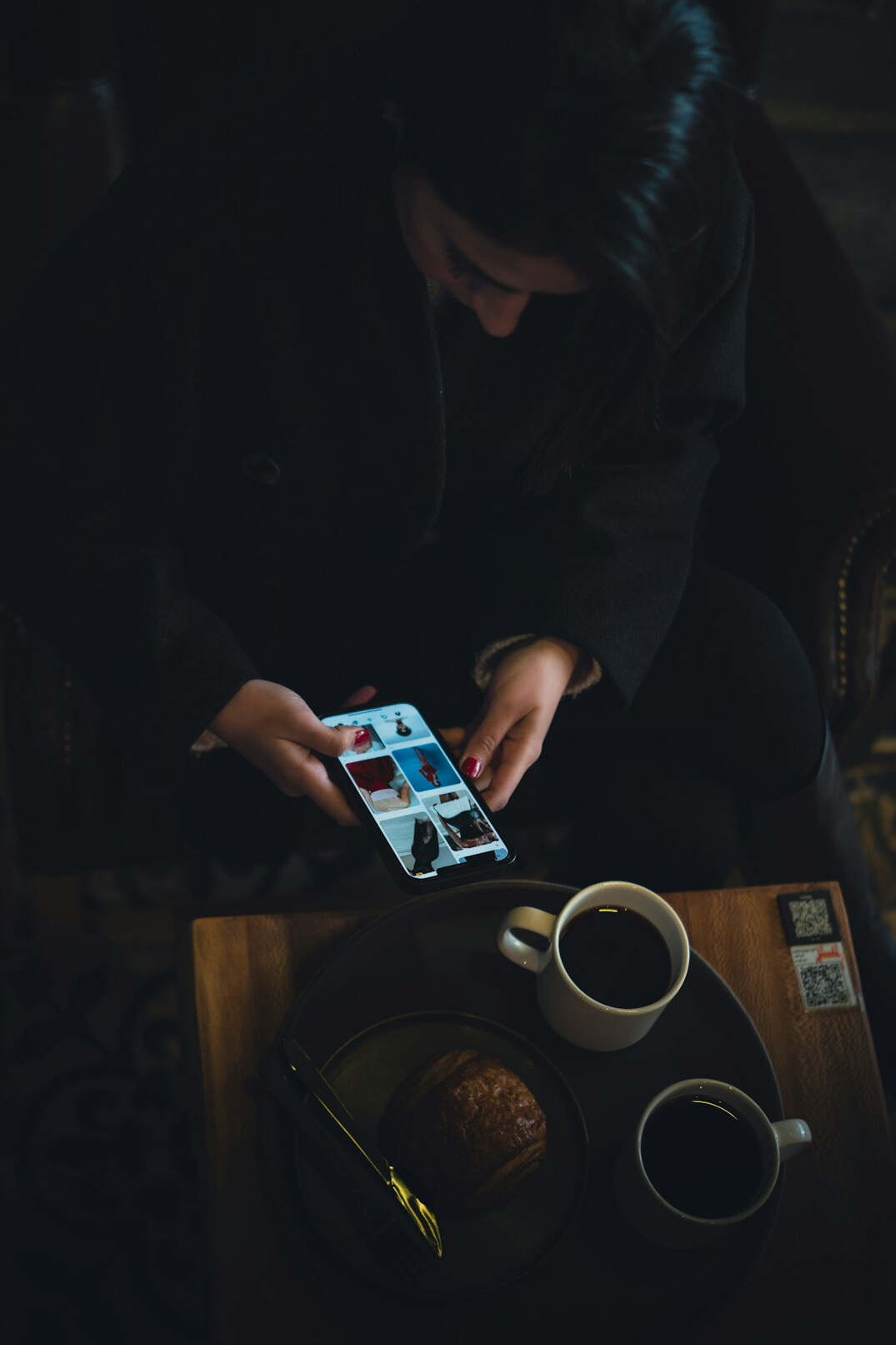 person using smartphone in cafe