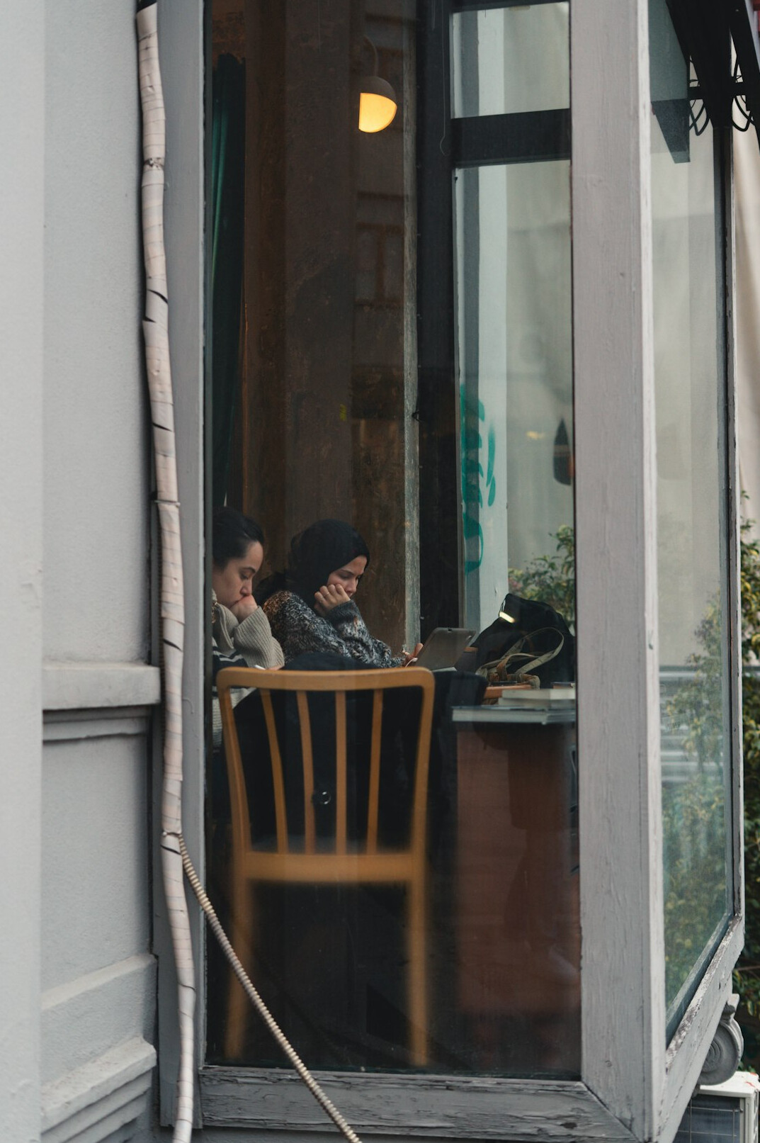 person reading book in cozy corner