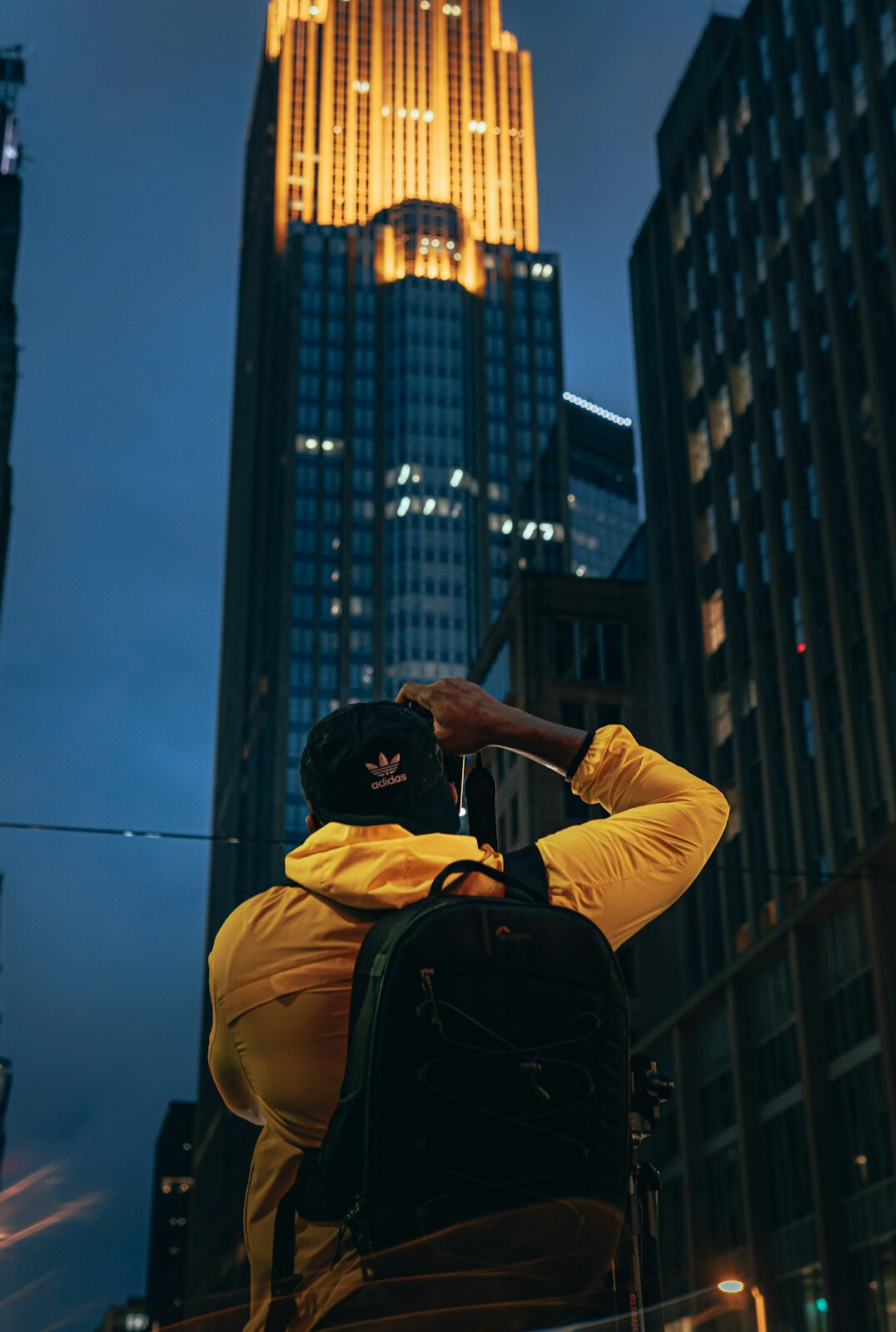 Photographer holding a camera while documenting a city street